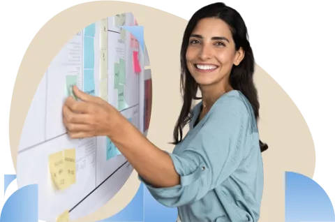 Woman in denim shirt smiling while using a water cooler dispenser