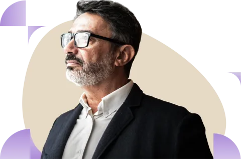 Man wearing glasses and dark blazer against beige circular background with purple accents