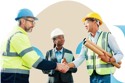 Three construction workers in safety gear shaking hands in front of a building structure
