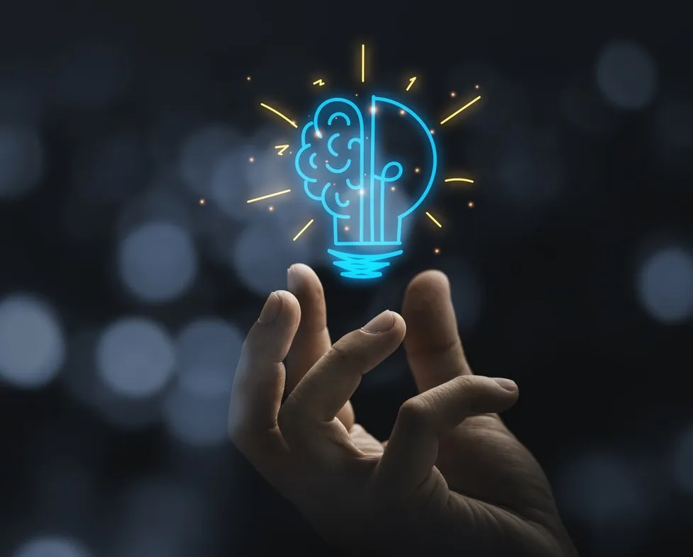 Main with light bulb and brain icon glowing in dark background
