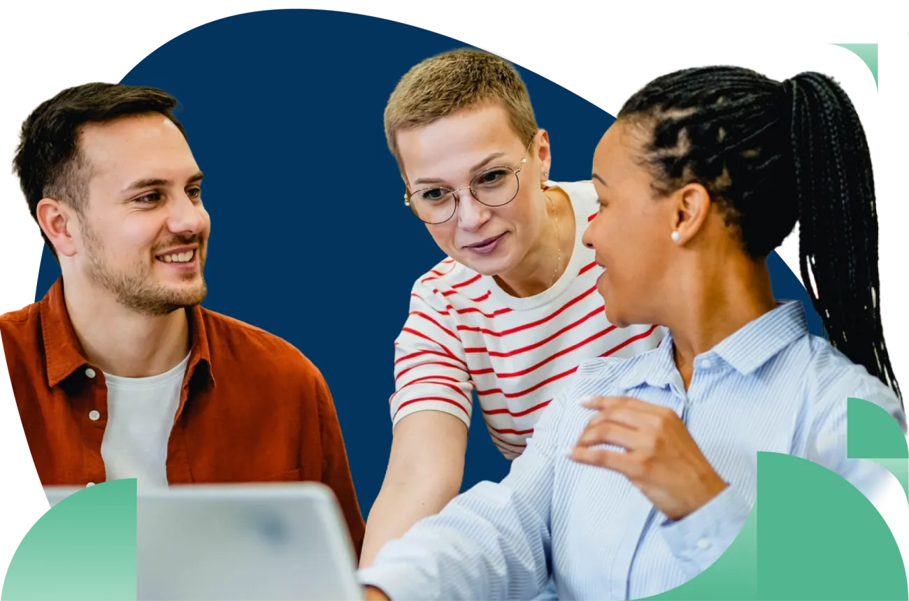 Three diverse professionals in casual attire having a discussion at a table with laptop