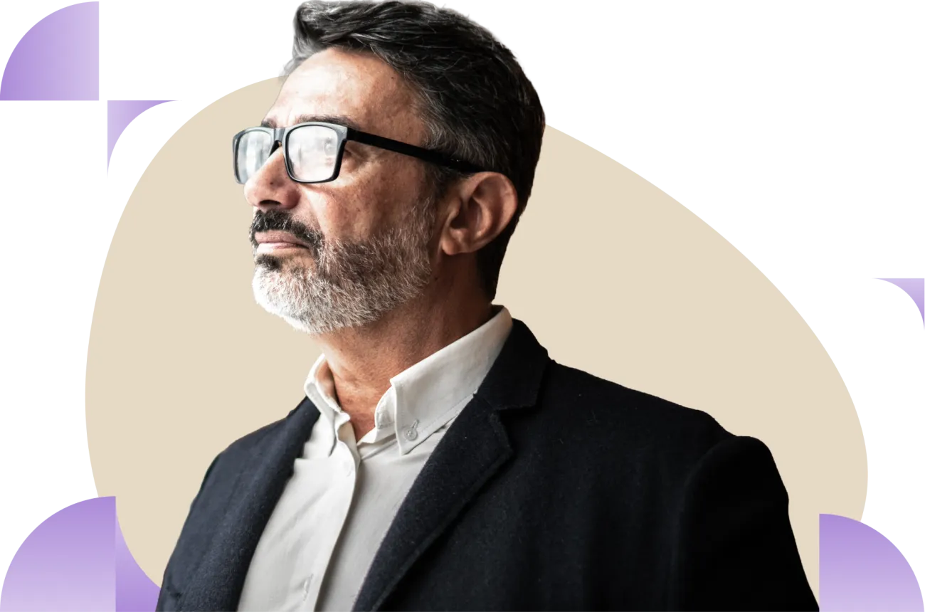 Man wearing glasses and dark blazer against beige circular background with purple accents