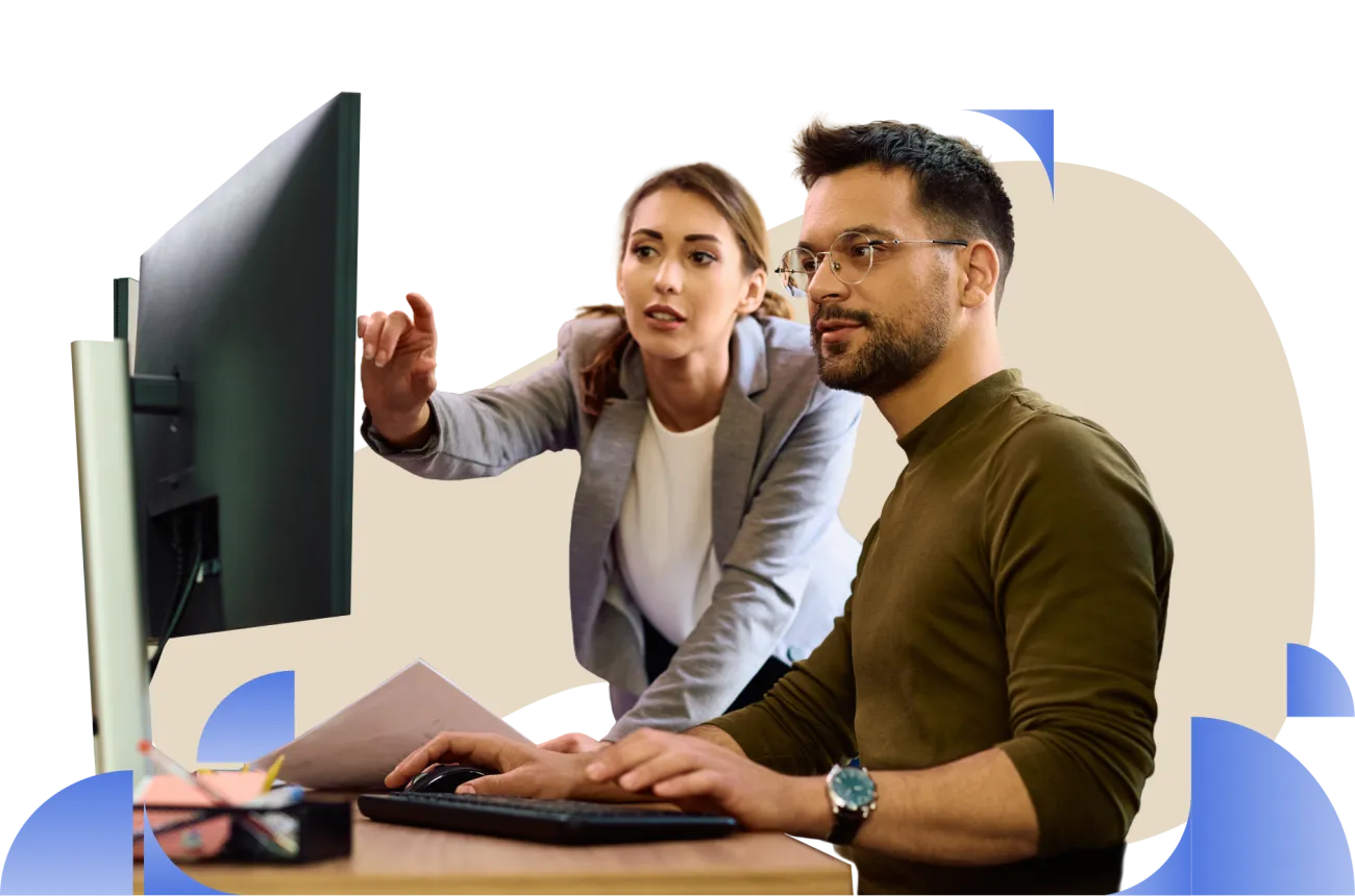 A man and a lady looking at a computer monitor during a discussion or presentation