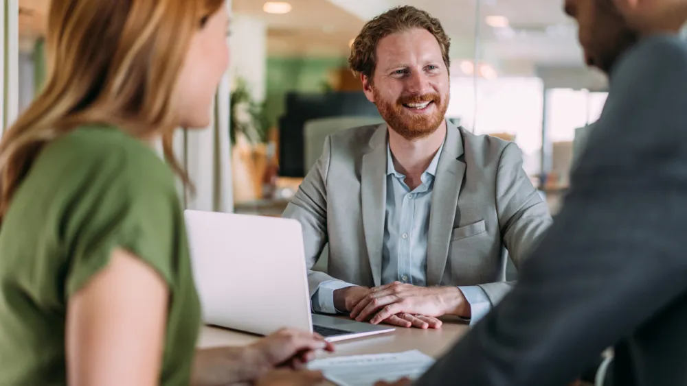 Smiling man in a business meeting with two colleagues