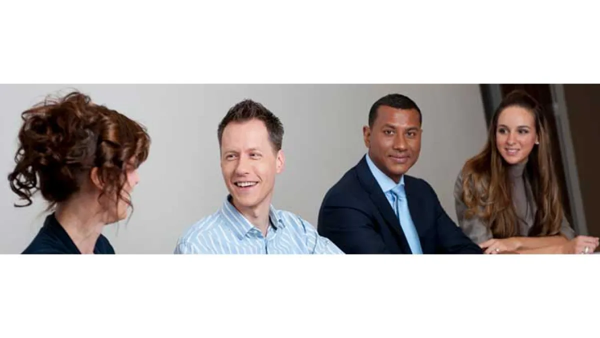 People smiling at a desk