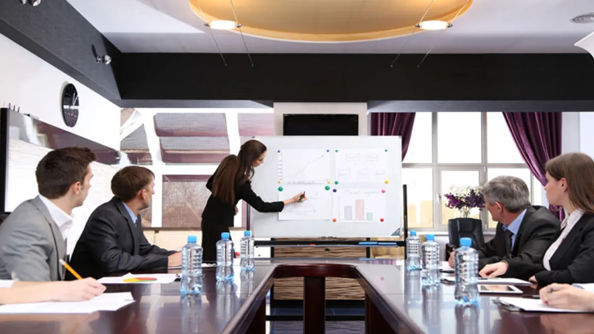 An InterProm classroom course being led by a suited lady