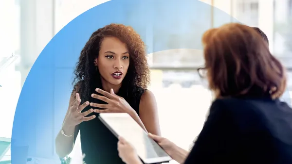 Colleagues in a professional discussion, with one holding a tablet